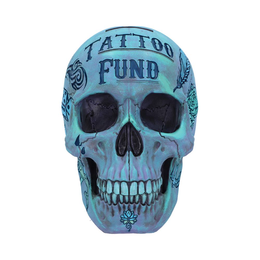 A blue skull faces forward with the full facial details on show. Two rows of teeth are on display with the eyes and nose hollowed out. On the front of the skulls forehead are the words tattoo fund and you can just see a wide slot where you could put coins into it.