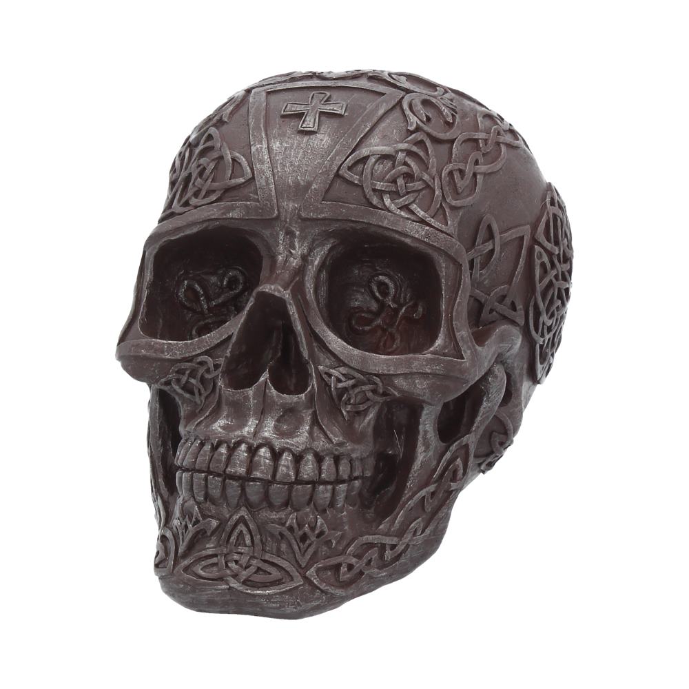 A front view of a large metallic iron looking skull covered in intricate celtic designs. The teeth are clenched and the eye and nose sockets are hollowed out. This is grey in colour and the patterning is very detailed.