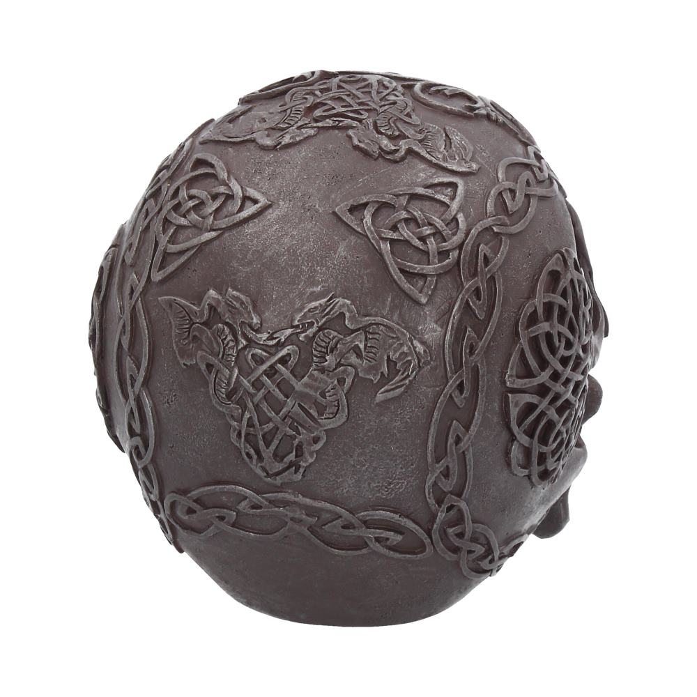 A grey iron looking skull is on a white background. This shows the rear of the item which features among the celtic designs two dragons either side of a patterned piece. 