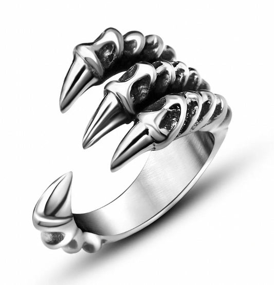 On a white background sits a silver coloured ring. This is in the shape of a dragons claw with an opening between three main claws and a smaller one the other side for adjustable sizing. There are detailed markings on the claws themselves.