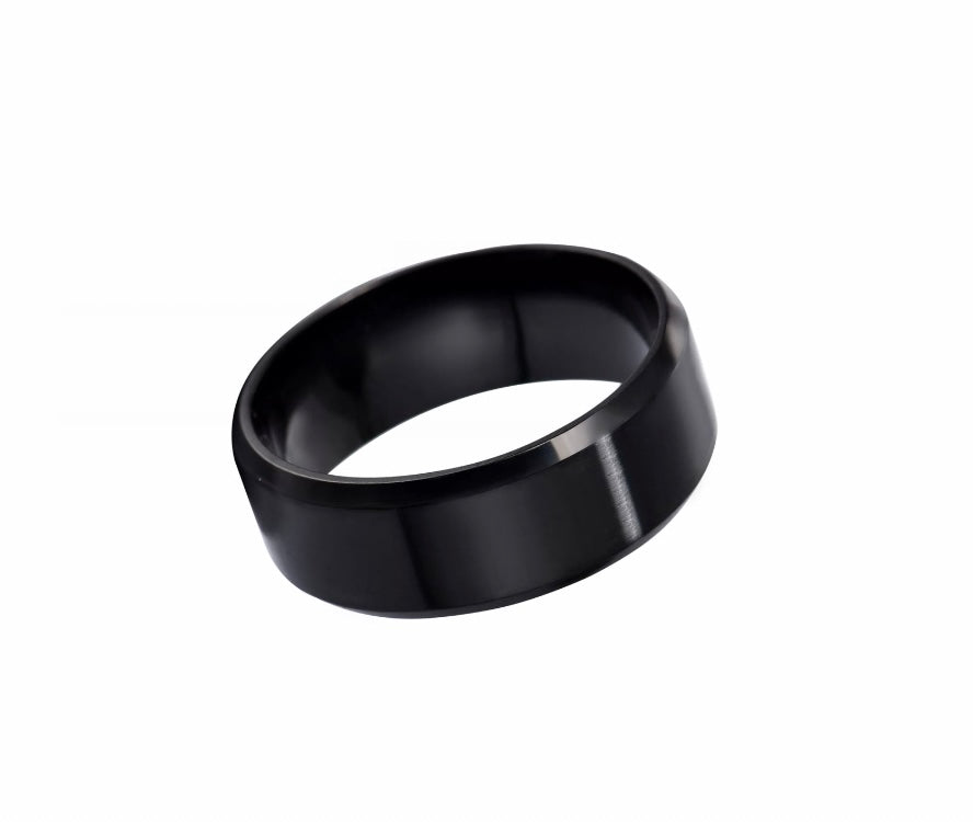 A side view of a plain black band style ring. It is black both on the outer and inner part of the ring. It is smooth to the touch and has a shine to it.